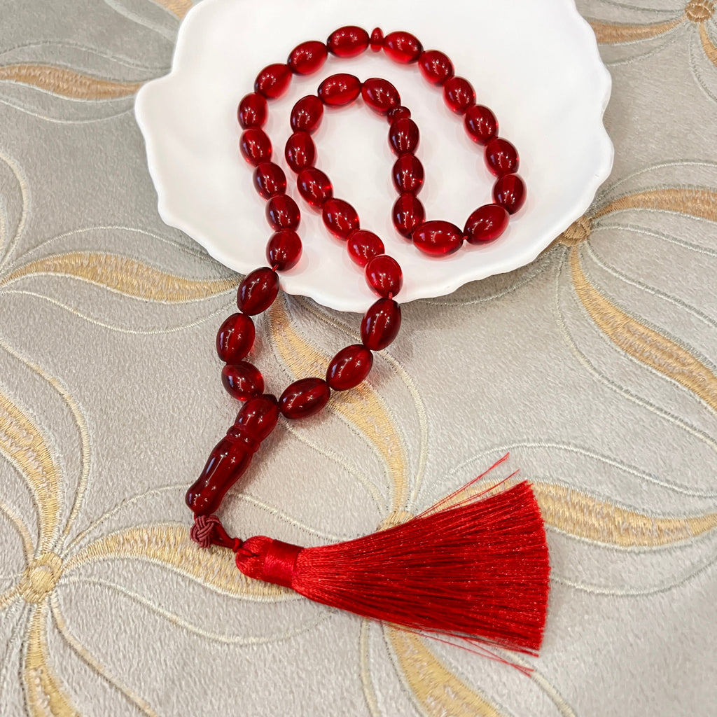 Ruby Red Tasbih arranged on a white dish