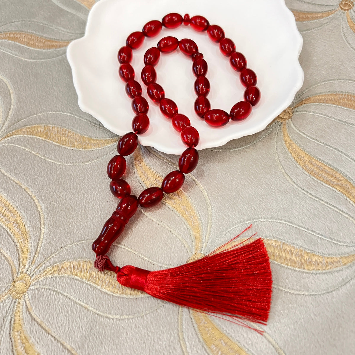 Ruby Red Tasbih arranged on a white dish
